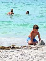 [Translate to deutsch:] Kind baut Sandburg am Golf auf der Insel Sanibel Island