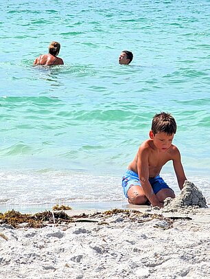 Child building a sandcastle on the Gulf at Sanibel Island