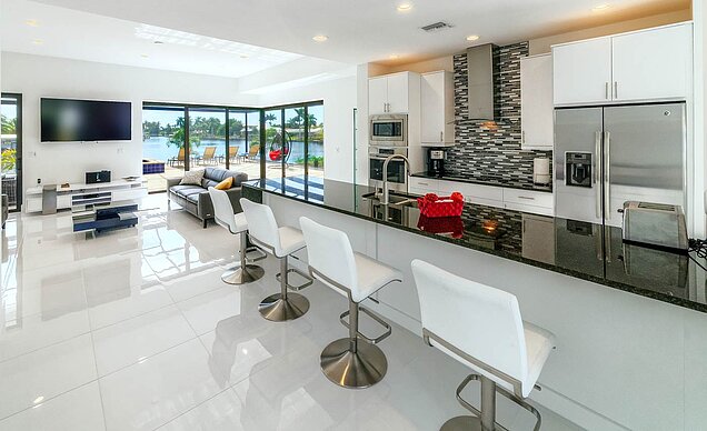 Spacious kitchen and large living room with water view in Villa Zeladace